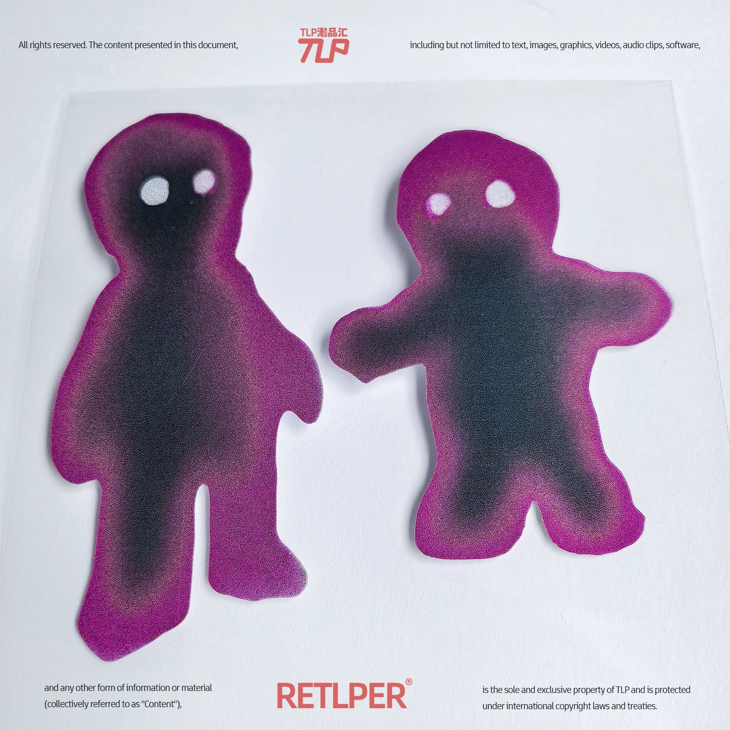 Two blurred pink figure reflective stickers photographed on white