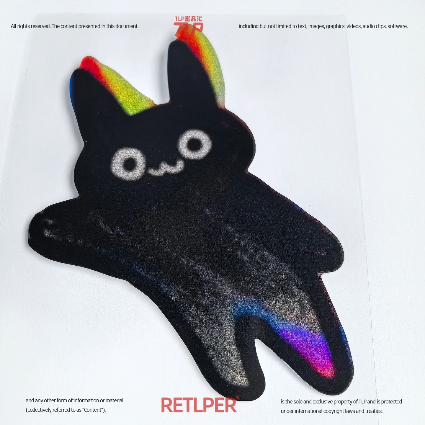 Black navigator bunny reflective sticker pointing left photographed on white