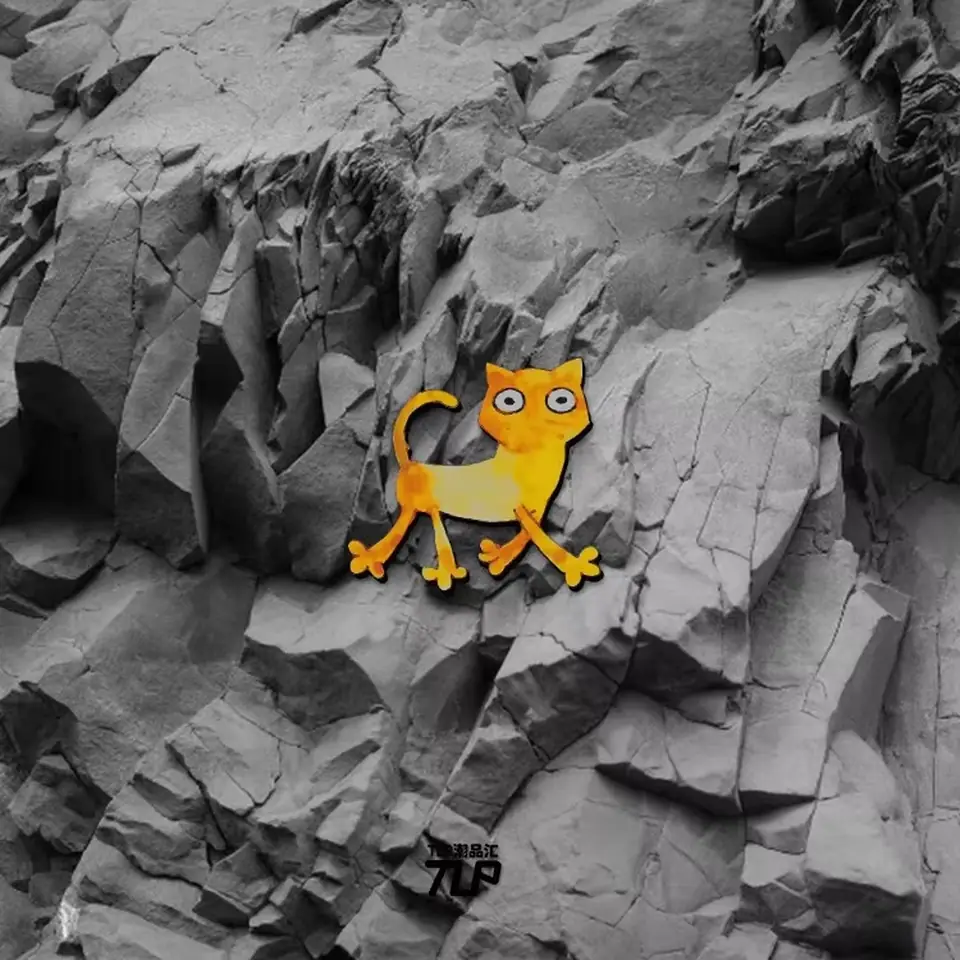 silly orange cat sticker on gray rock background
